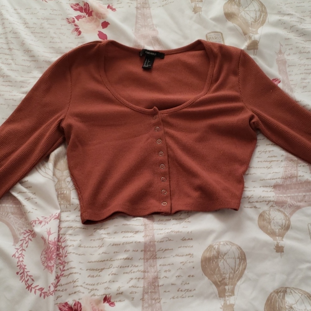 A brownish red crop top